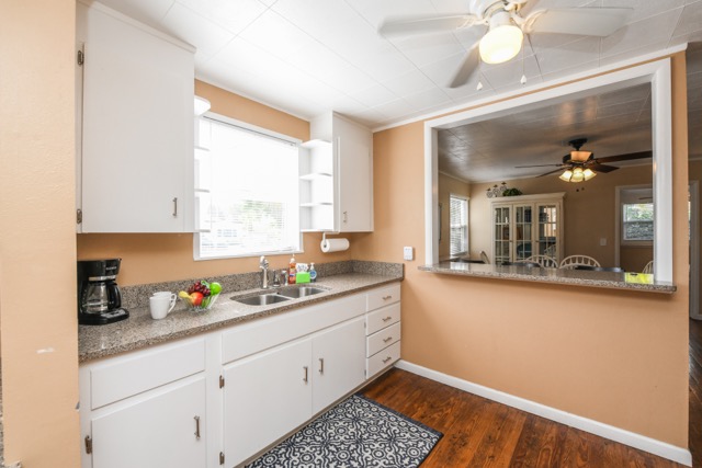 The kitchen has two separate work areas with dual sinks.