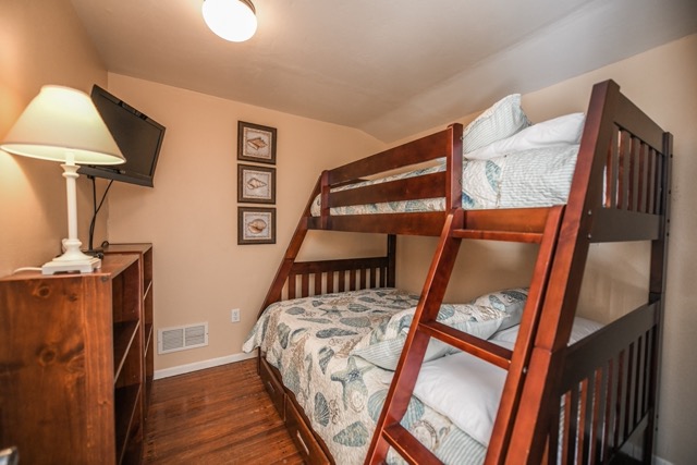 The third bedroom has a twin/full bunk bed 
and a wall mounted flat screen TV.
